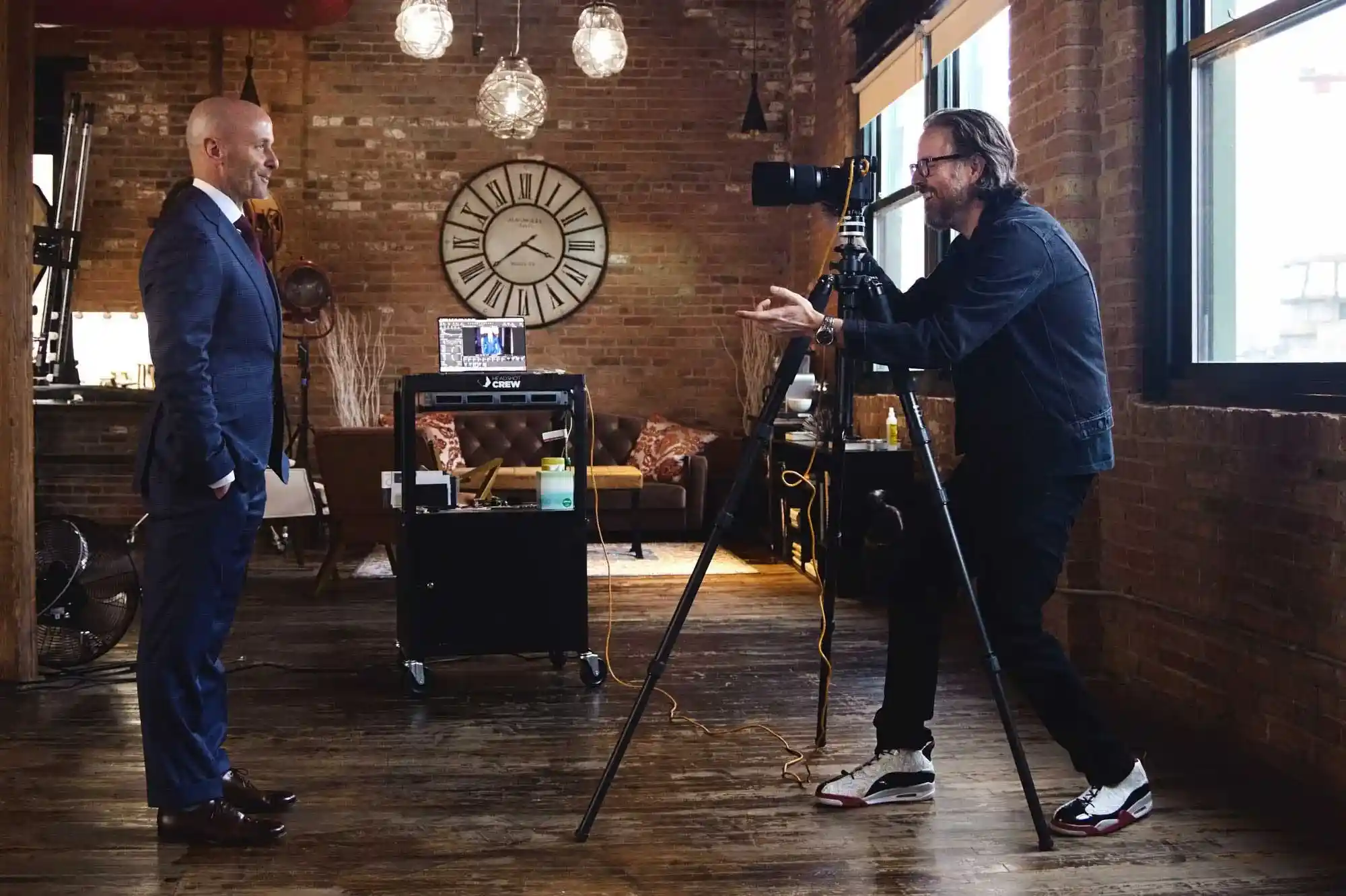Professional Headshots: BTS shot of Michael Schacht photographing man in business suit Behind the scenes shot of business man being photographed by celebrity portrait and headshot photographer Michael Schacht at his chic west loop headshot studio