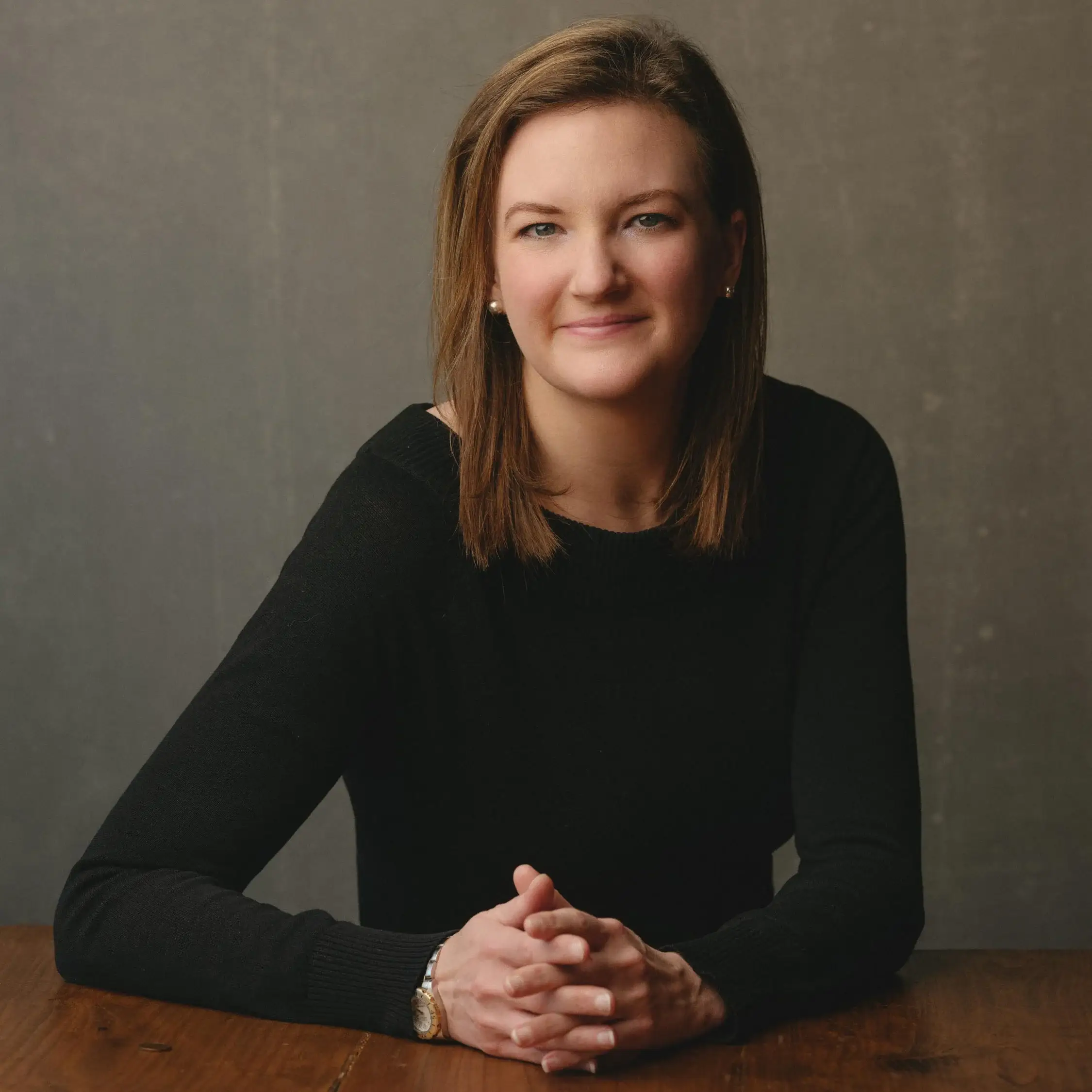 Cara Headshot Testimonial Vanity Fair-inspired corporate portrait of a professional individual posing confidently against a hand-painted backdrop, showcasing a stylish and artistic flair