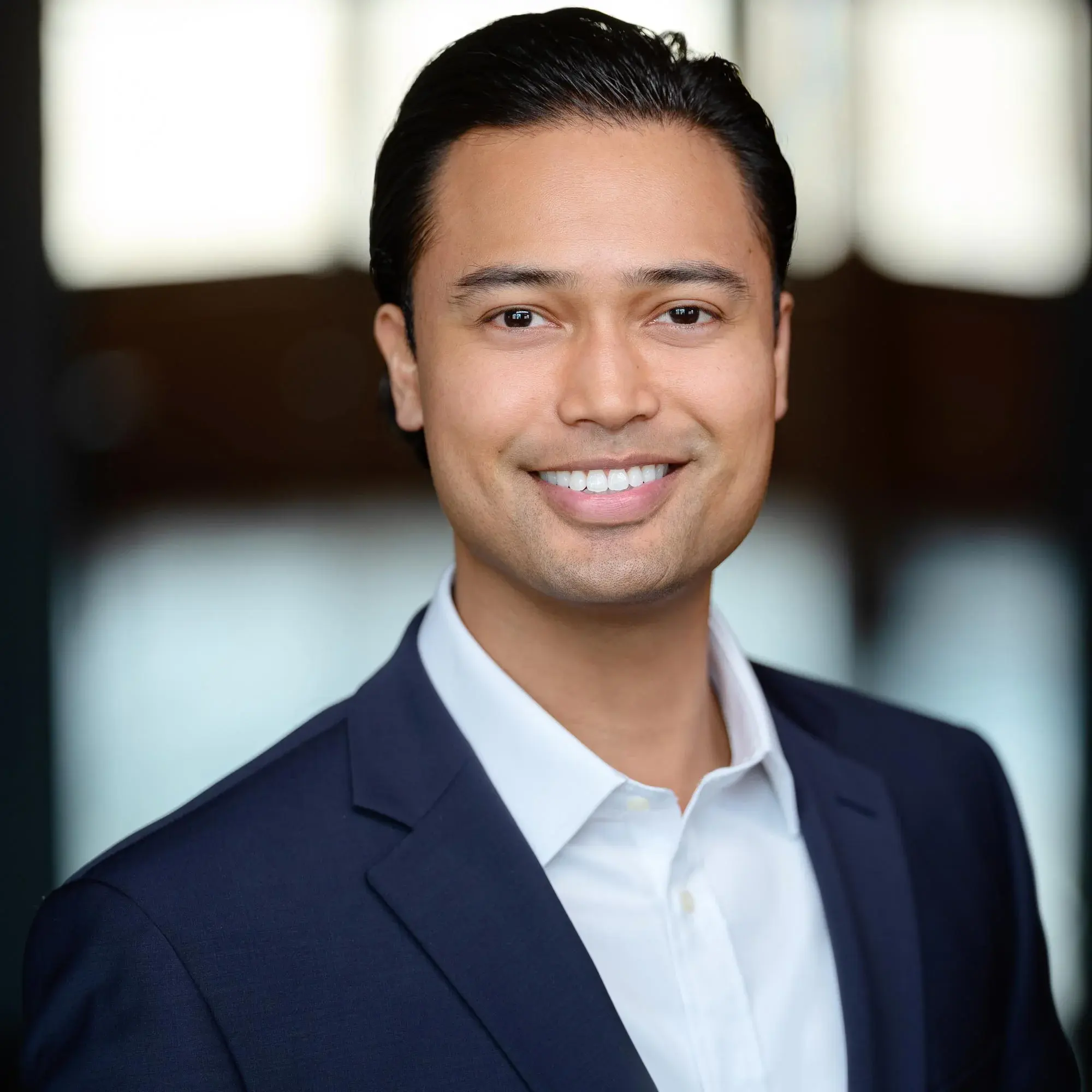 CJ Nelson Headshot Professional headshot of a young, hip, and attractive businessman in a stylish suit, ideal for a LinkedIn profile