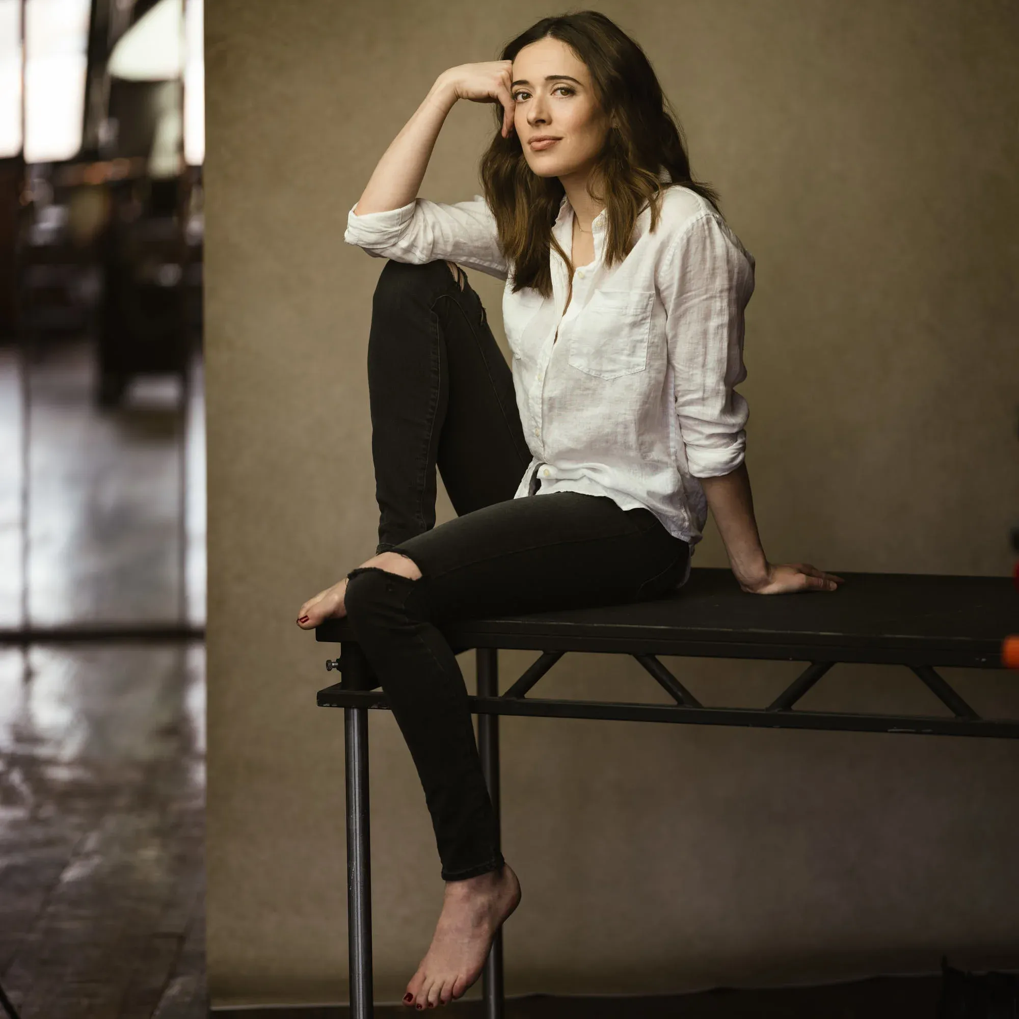 Chicago PD’s Marina Squerciati – From Stage to Screen in the Windy City Marina Squerciati sits casually on stage, urban Chicago scenery visible, embodying her Chicago PD character's strength