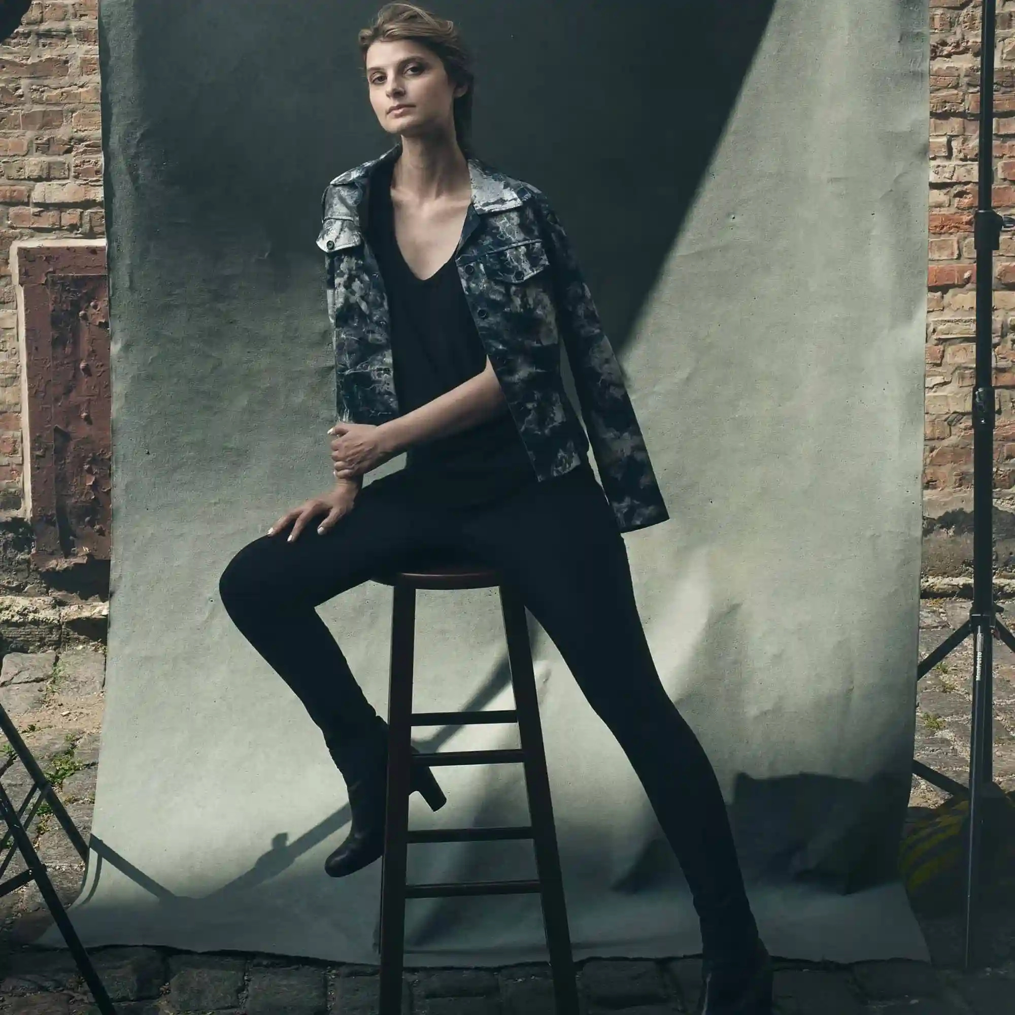 Empowered Voice: Alicia Kozak’s Portrait in Chicago’s Backstreets Motivational speaker Alicia Kozak photographed in atmospheric Chicago alley, her presence commanding against weathered brick and shadows in Fulton Market's hidden passages.