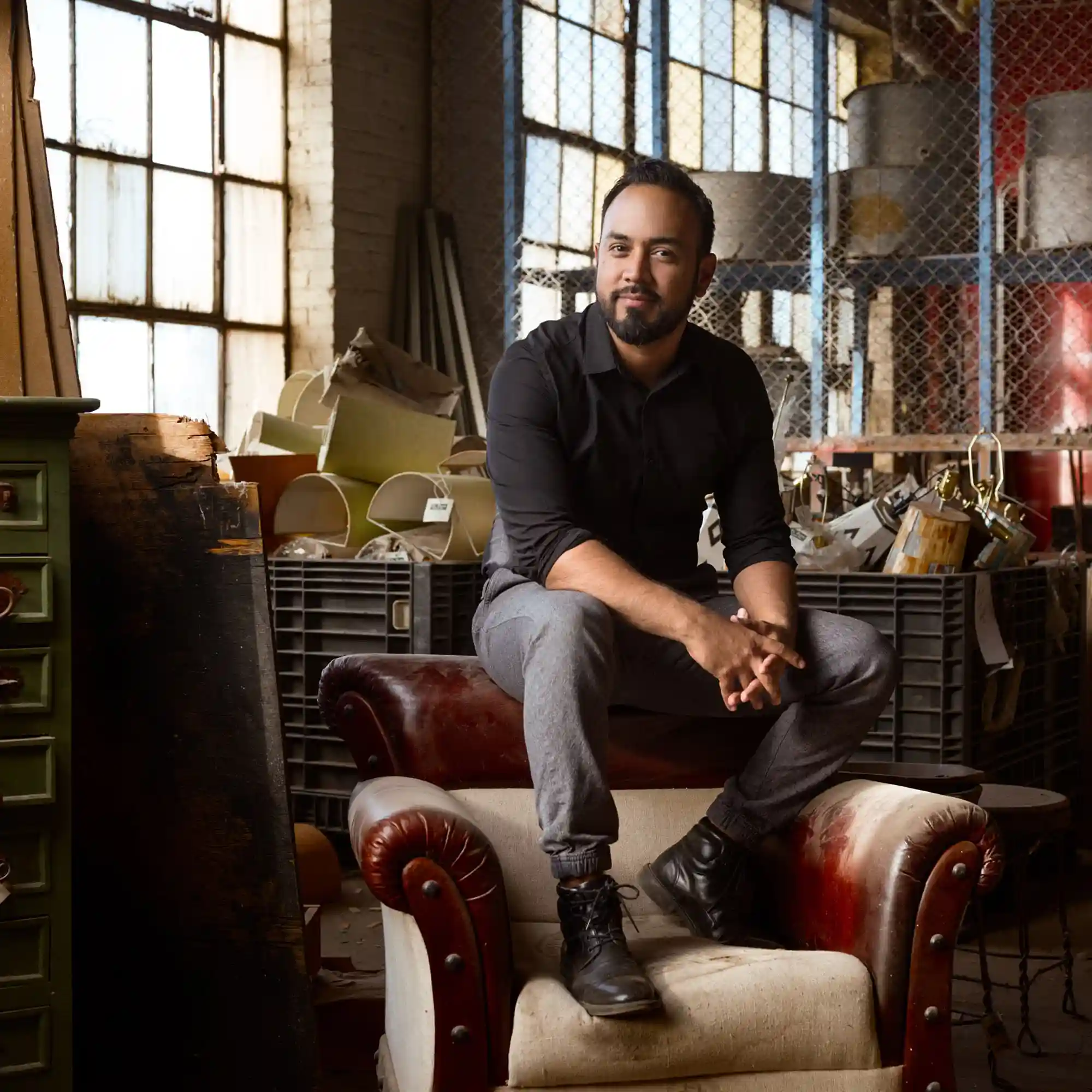 Hispanic Entrepreneur Portrait on Red Chair Portrait of a Hispanic entrepreneur seated on a striking red chair, capturing the essence of leadership and entrepreneurial spirit.