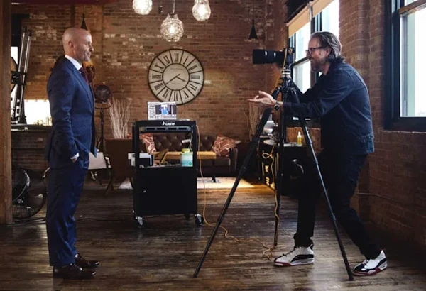 Behind the scenes shot of business man being photographed by celebrity portrait and headshot photographer Michael Schacht at his chic west loop headshot studio
